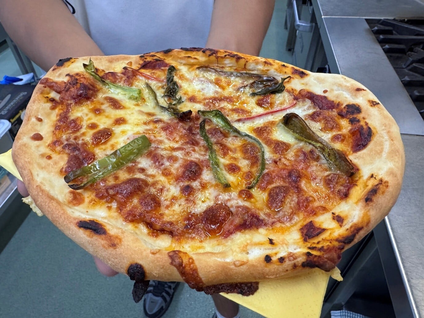 A finished pizza made with produce grown in the Gilson College kitchen garden